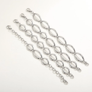 Detailed view of silver oval link chains with lobster clasps and extension adjusters