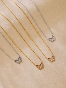 Detail view of colorful zircon butterfly necklaces in gold and silver stainless steel