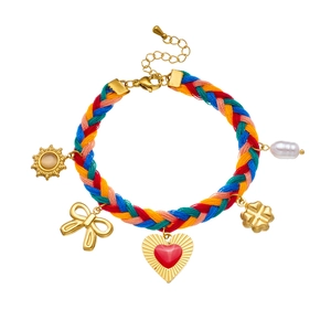 Colorful woven rope bracelet with gold sun charms, heart pendant, and pearl accessory