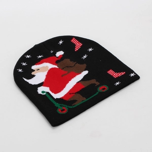 Detail of black knit beanie featuring jacquard Santa on scooter and snowflake patterns