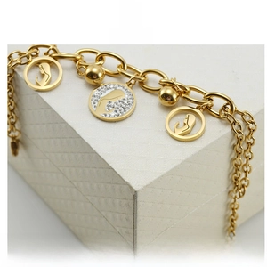 Detail of 18K gold-plated bracelet with hollow face silhouette and rhinestone charms