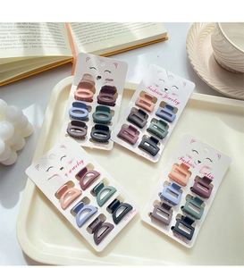 Detailed view of matte mini hair claw clips set displayed on decorative packaging cards