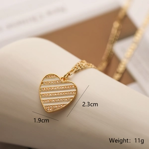 Macro shot of gold heart pendant with dimensions 2.3cm by 1.9cm and 11g weight info