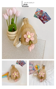 Detail of hand-woven straw crossbody bag for kids featuring a large pink flower and smile