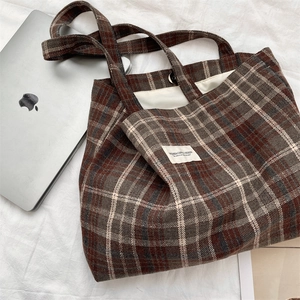 Close-up of vintage wool plaid tote bag with magnetic clasp and internal lining