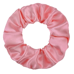 Detailed view of the soft pink satin fabric texture and pleated folds of the scrunchie