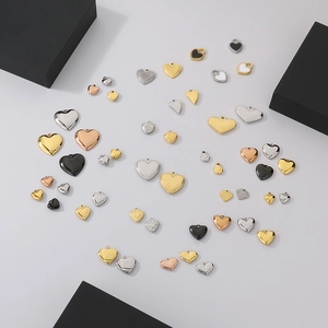 Polished stainless steel heart pendants in gold and silver finishes on a clean background