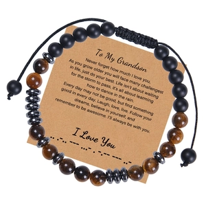 Detailed view of Morse code tiger eye stone beads bracelet on a kraft gift card