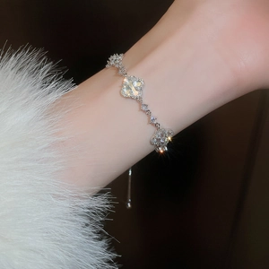 Detailed view of silver clover bracelet featuring mother of pearl and adjustable clasp