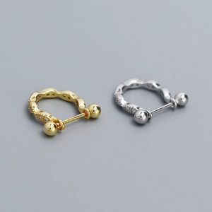 Macro detail of S925 silver geometric screw-back studs with sparkling cubic zirconia