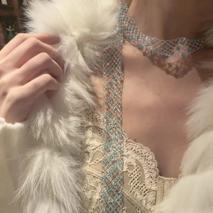 Elegant blue glass beaded hollow mesh necklace for women on a model with white faux fur coat