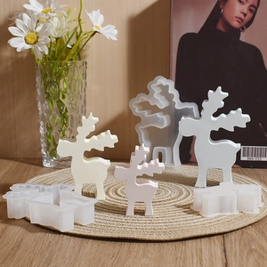 DIY Christmas elk resin silicone molds in various sizes shown on a textured rustic mat