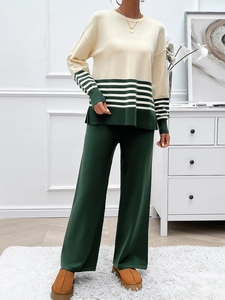 Detail view of contrast stripe knit top and dark green wide-leg trousers set
