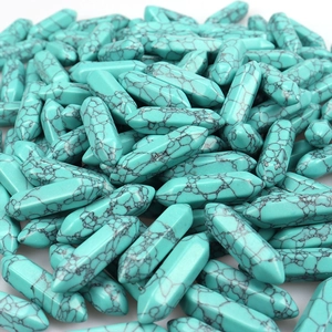 Pile of hexagonal turquoise crystal pillars for jewelry making with unique black veins