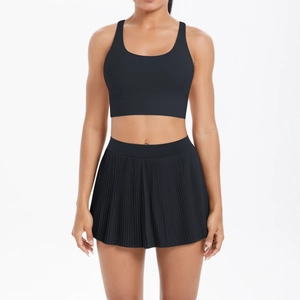 Detail of black sports yoga set with U-neck bra and high-waisted pleated tennis skirt