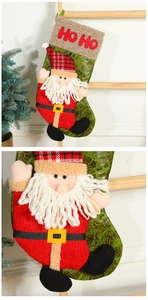 Macro detail of Christmas stocking with 3D Santa Claus and HO HO embroidery texture