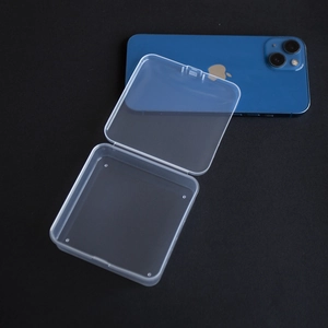 Compact square transparent PP storage box shown next to a smartphone for size reference