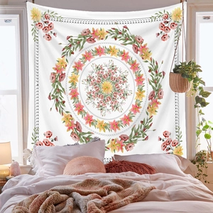 Bohemian mandala tapestry with pink and yellow flowers hanging in a sunny bedroom decor