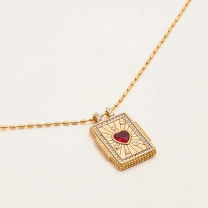 Detail of 18K gold stainless steel pendant with red heart zircon and ball chain