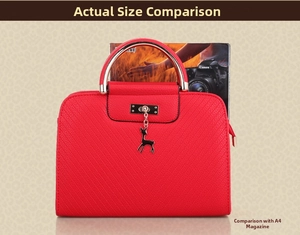 Red handbag size comparison with A4 magazine showing V-quilted texture and deer pendant