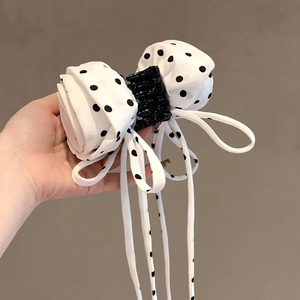 Polka dot bow claw clip with long fabric tassels and white floral fabric design