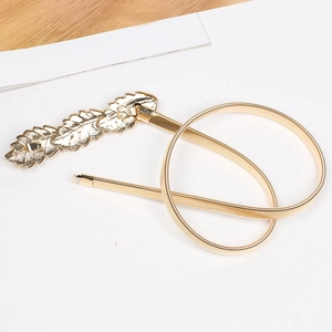 Detailed macro view of the golden metal leaf buckle and elastic spring chain belt