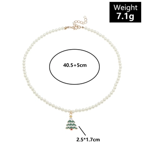 Close-up of pearl necklace with green Christmas tree pendant and size measurements
