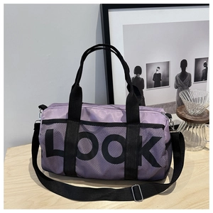 Detail of a large purple travel tote with black straps and LOOK letter print