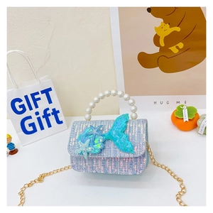 Detail of blue tweed girl's handbag with mermaid tail decor and pearl handle