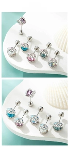 Macro detail of colorful seashell cartilage studs with pearls and starfish accents