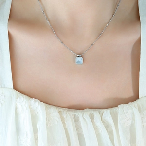 Silver satellite chain necklace featuring a square light blue shell pendant on a model