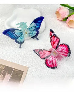 Detail of blue and pink butterfly hair claws with realistic wing textures and metal springs