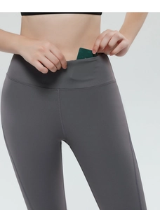 Detail of high-waisted yoga shorts featuring a functional hidden waistband card pocket