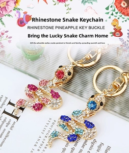 Detail of rhinestone snake keychains with colorful crystals and gold-plated alloy hooks