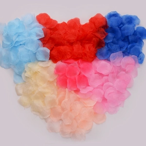 Artificial rose petals in mixed colors arranged in a heart shape for wedding decor