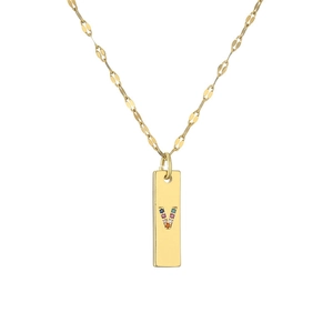 Detail view of a gold-plated necklace featuring a letter V pendant with colorful stones