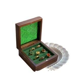 Vintage walnut wood jewelry box with green embossed glass lid and velvet ring storage