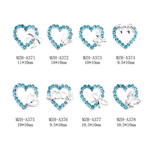 Light blue heart and bow alloy nail charms with rhinestones set on white background
