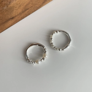 Detailed view of S925 sterling silver beaded rings with elegant white pearls on top