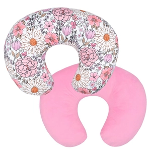 Detail of U-shaped nursing pillow set with pink floral cover and soft cotton texture