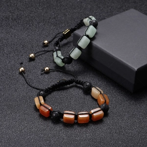 Handmade woven bracelet with rectangle green and orange agate stones on black background