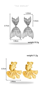 Detailed view of silver fish tail and gold ginkgo leaf earrings with dimensions
