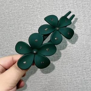 Elegant dark green acrylic floral hair claw clip with silver rhinestones and matte finish
