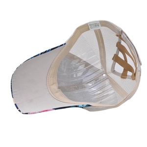 Detail of floral baseball cap mesh back with crossed ponytail hole and fabric label