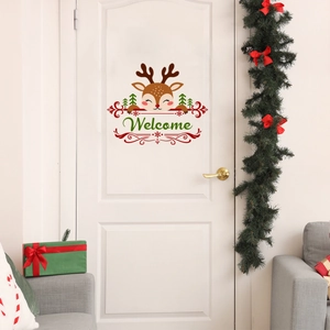 Christmas reindeer door sticker with Welcome text on white door with festive holiday wreath