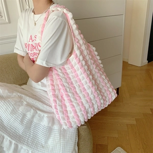 Detailed close-up showing the pink and white bubble texture of the shoulder tote bag