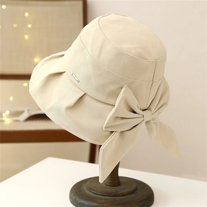 Women's wide brim sun hat in beige with large bow detail and elegant French style