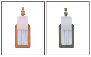 Detail view of orange and green PU leather luggage tags with buckle straps and ID cards