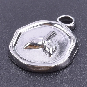 Macro shot of silver polygon pendant featuring embossed whale tail motif for DIY jewelry