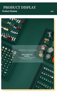 Detailed macro view of dark green velvet jewelry tray showing ring slots and earring holders